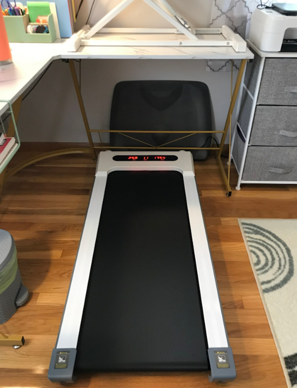 white and black walking pad treadmill under standing desk