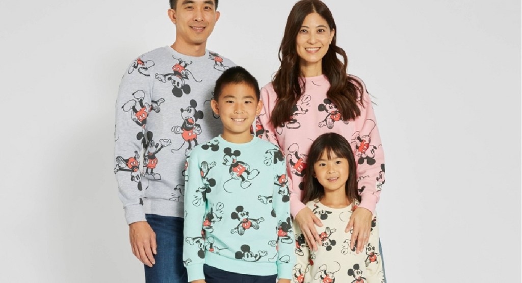 family wearing disney sweaters