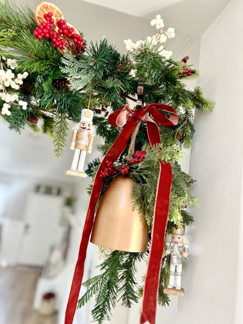 faux bell and velvet ribbon hanging on a garland