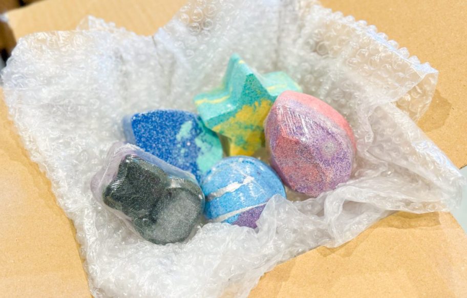 five bath bombs in box with bubble wrap