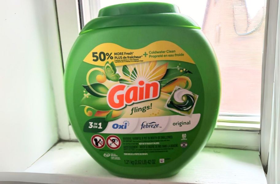 a gain flings 76 count container on a window sill