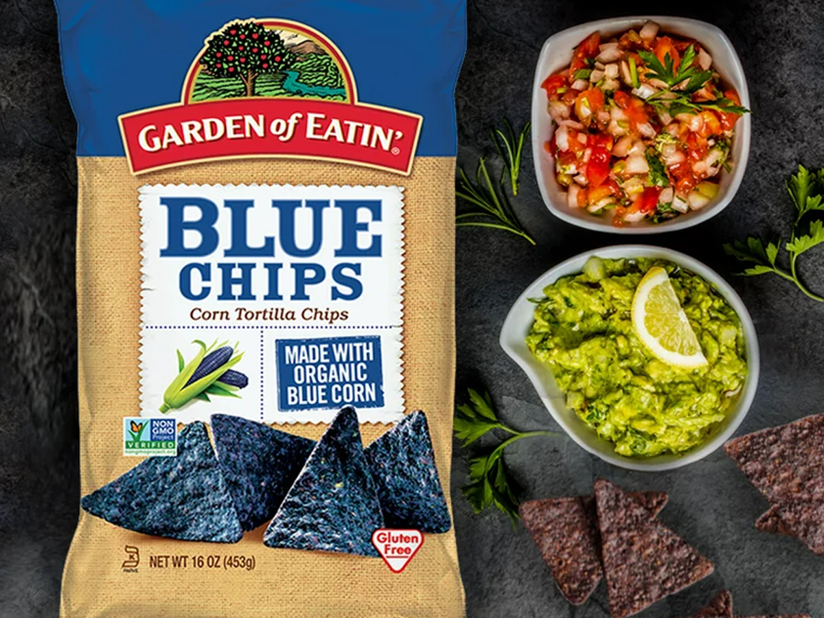 garden of eatin tortilla chips bag with bowls of guac and salsa