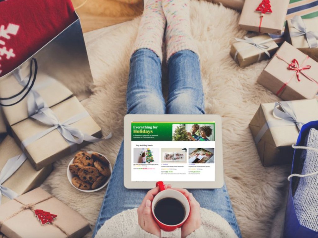 woman holding ipad with groupon website and coffee mug