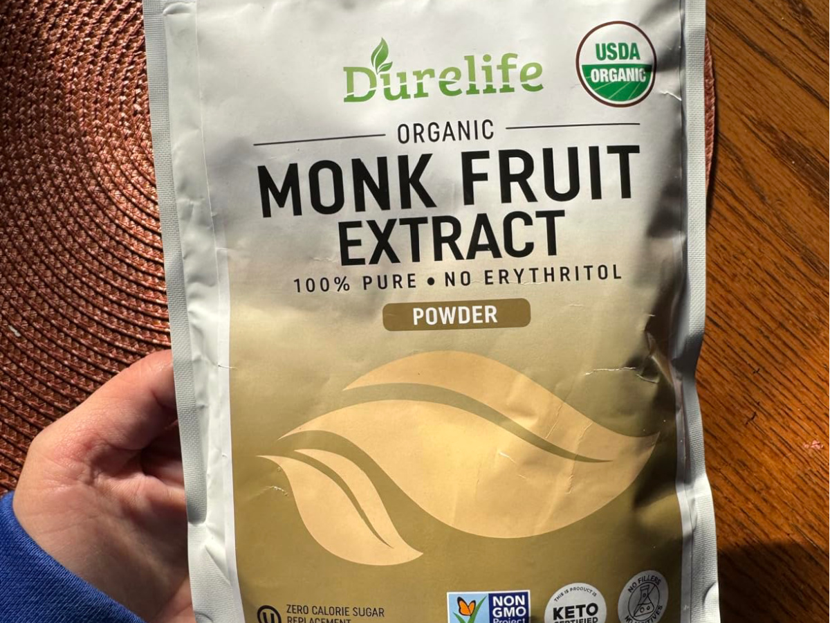 hand holding Durelife Organic 100% Pure Monk Fruit Sweetener Extract Powder