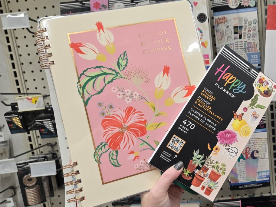 hand holding floral planners 