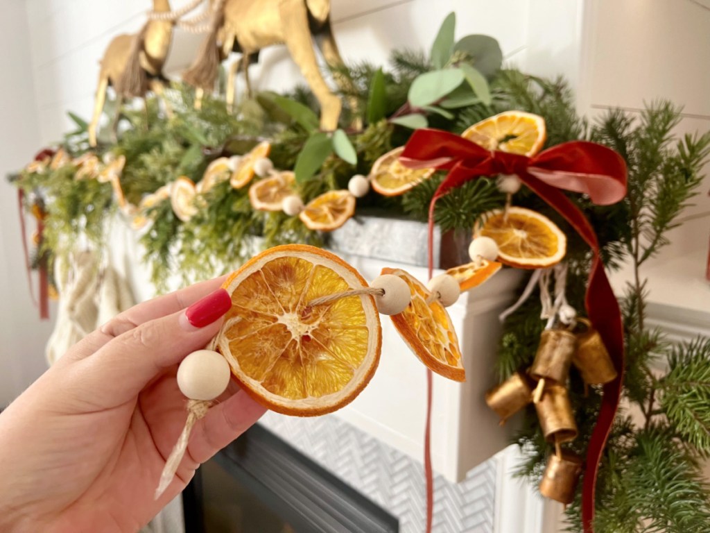 holding orange slices christmas garland