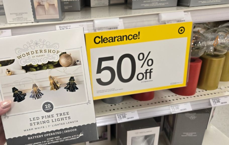 a 50% off target clearance sign next to holiday decor items