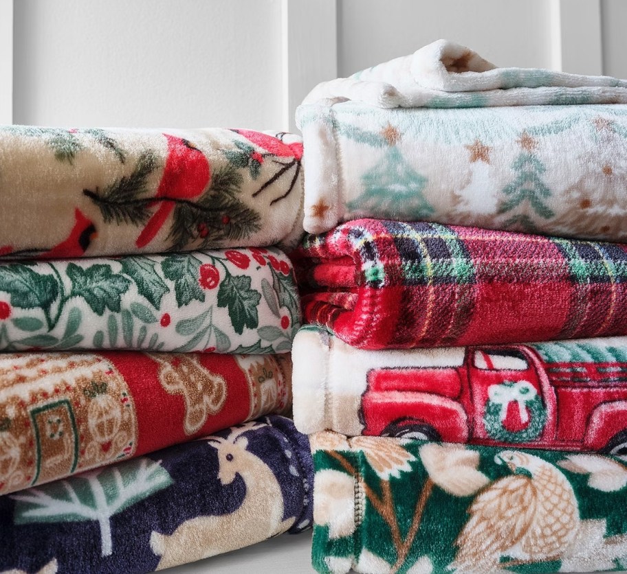 assorted holiday throws folded and stacked