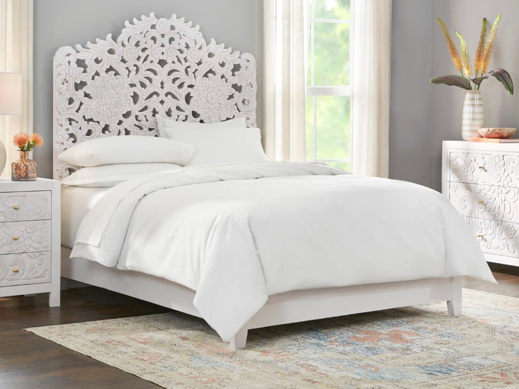 home decorators white carved headboard in bedroom with white comforter set