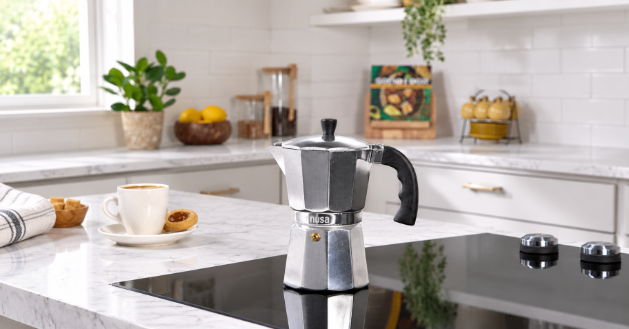 a silver stovetop coffee maker in a kitchen
