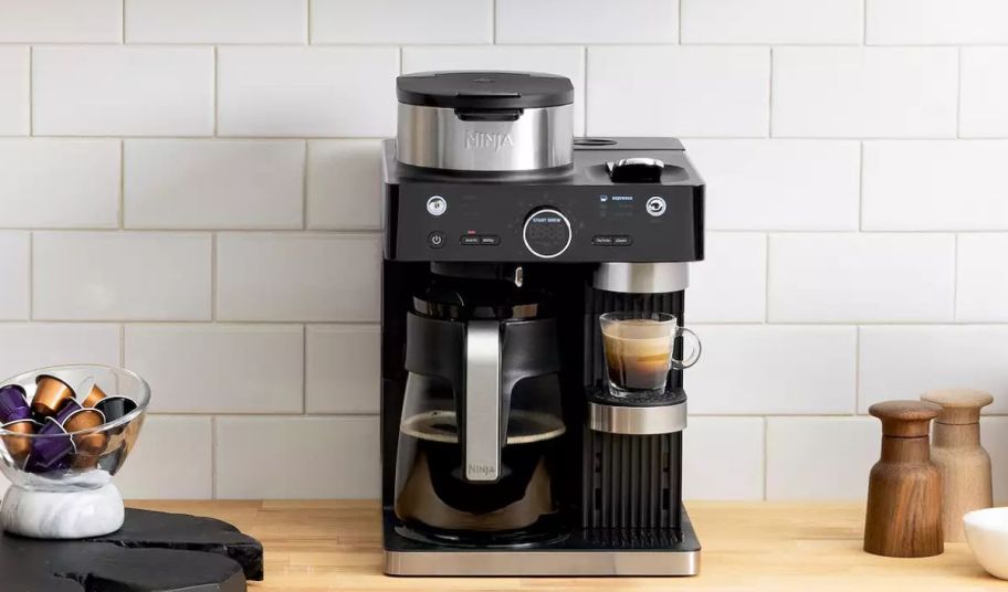 the ninja Espresso Coffee Barista System on a kitchen counter brewing a cup of coffee