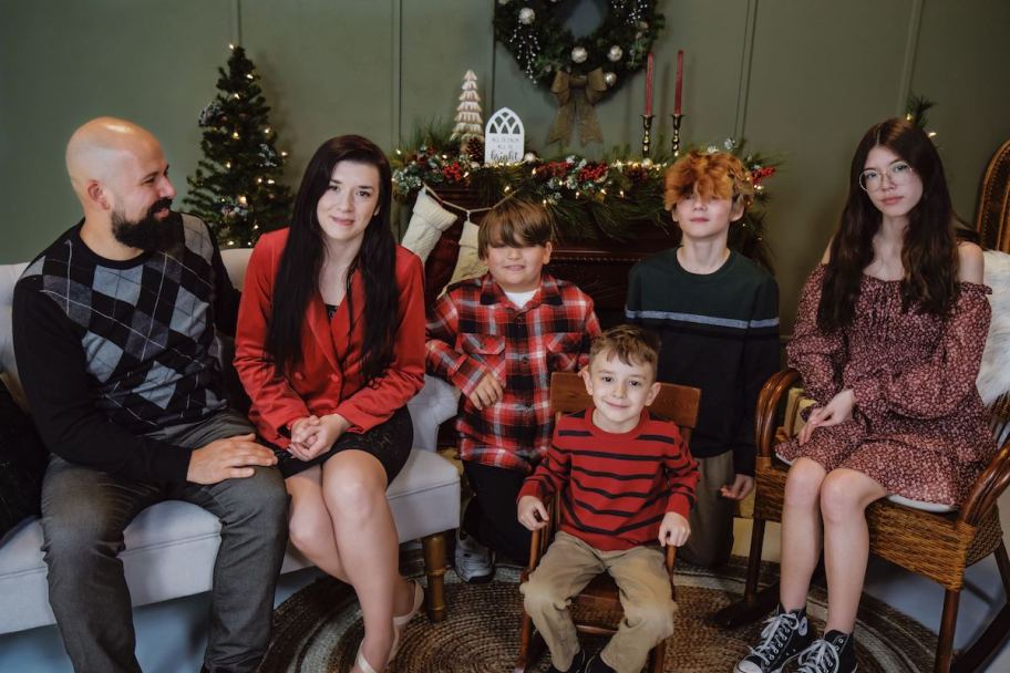 christmas family sitting in decorated holiday room