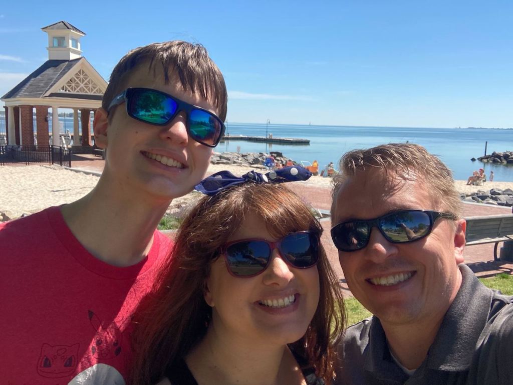 Family taking selfie in front of ocean