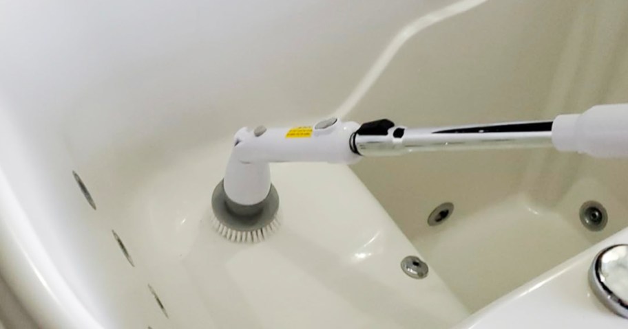 white and gray electric spin brush cleaning bathtub