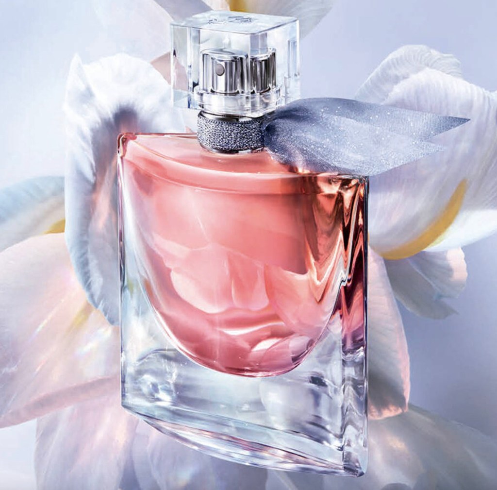 bottle of pink perfume with silver ribbon