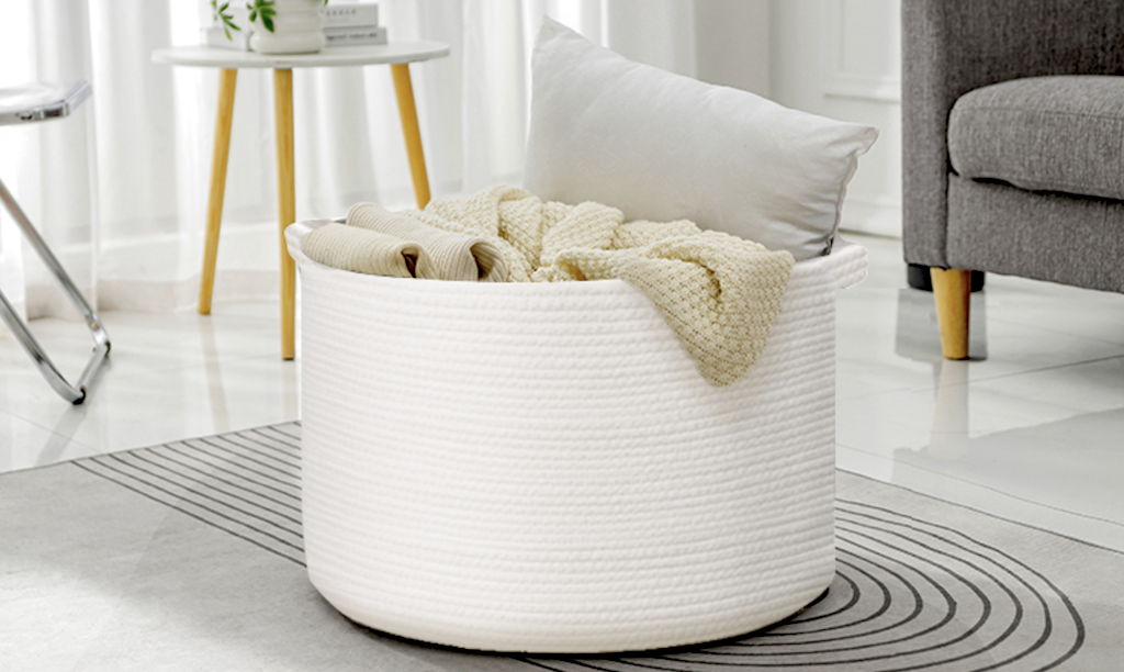 large white rope basket with blankets and pillows 
