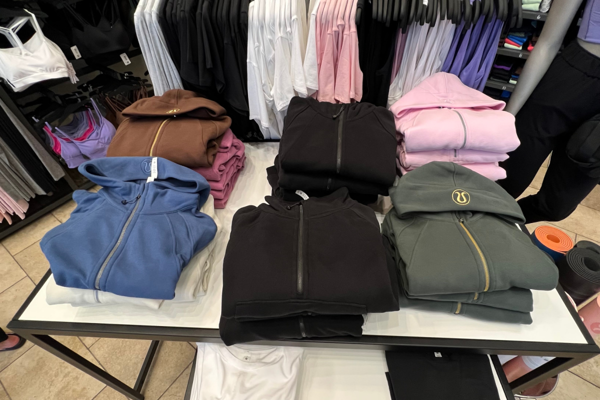 folded hoodies and sweatshirts on table in store