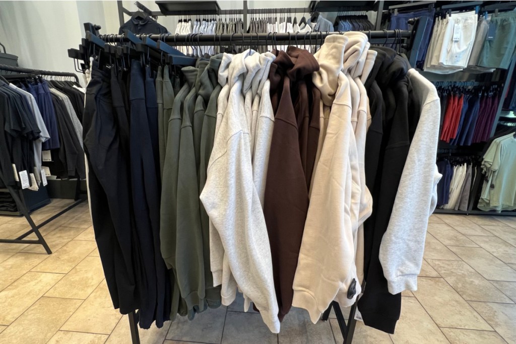hoodies and sweatshirts on hanging rack in store