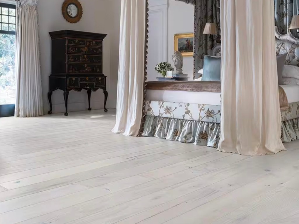 white hardwood flooring in bedroom with canopy bed