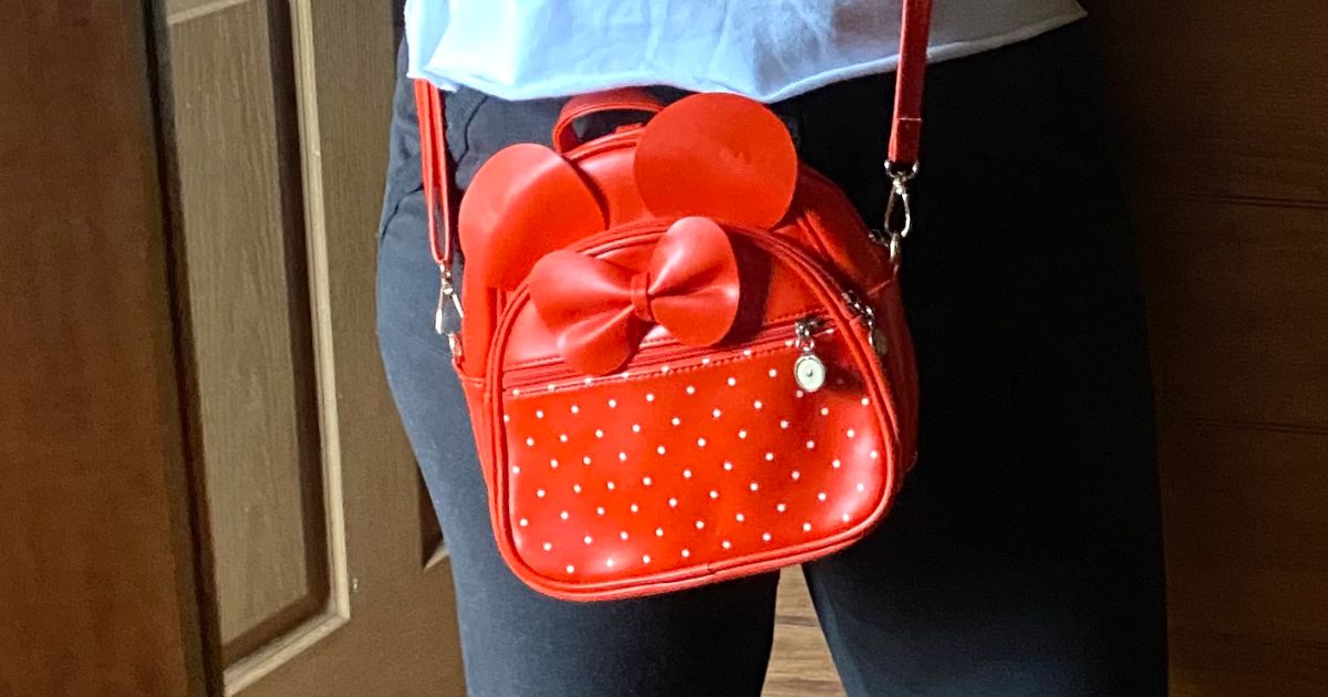 a woman wearing a mini backpack in red