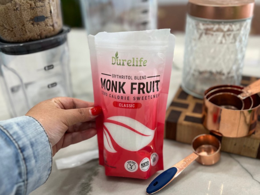 monk fruit sweetener bag next to measuring spoons and a blender