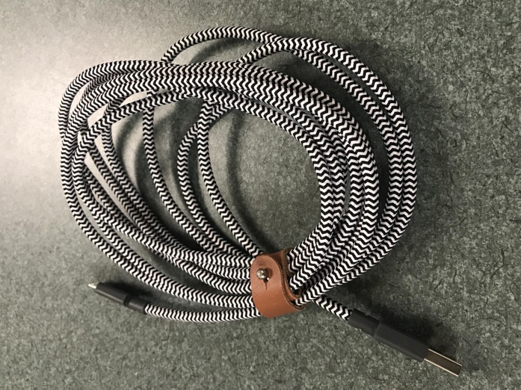 lightning cable bound by a leather tie