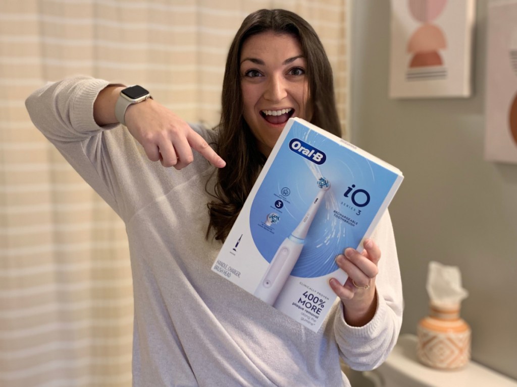 woman pointing at toothbrush box