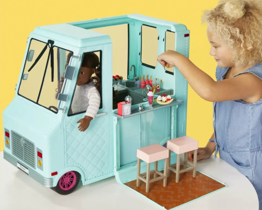 girl playing with doll ice cream truck