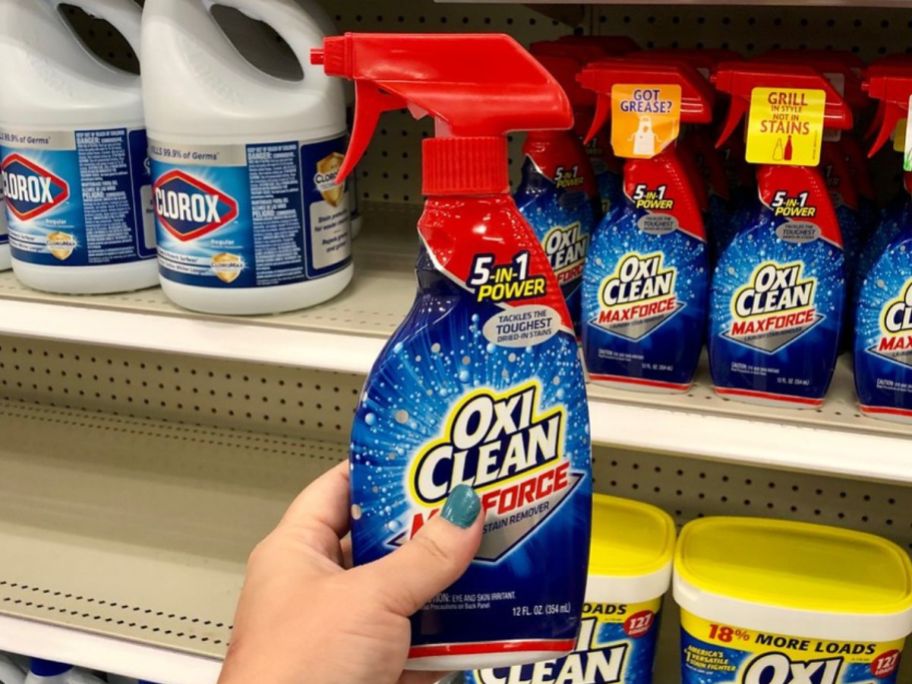 bottle of oxiclean maxforce being held up by hand