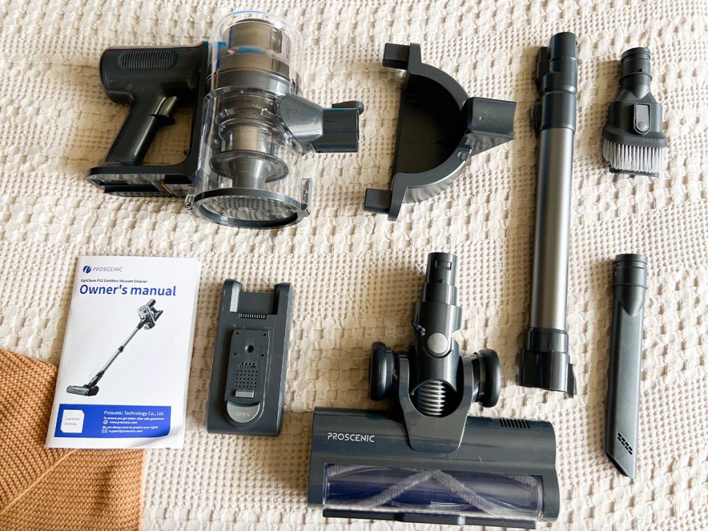 proscenic vacuum parts laid out on bed