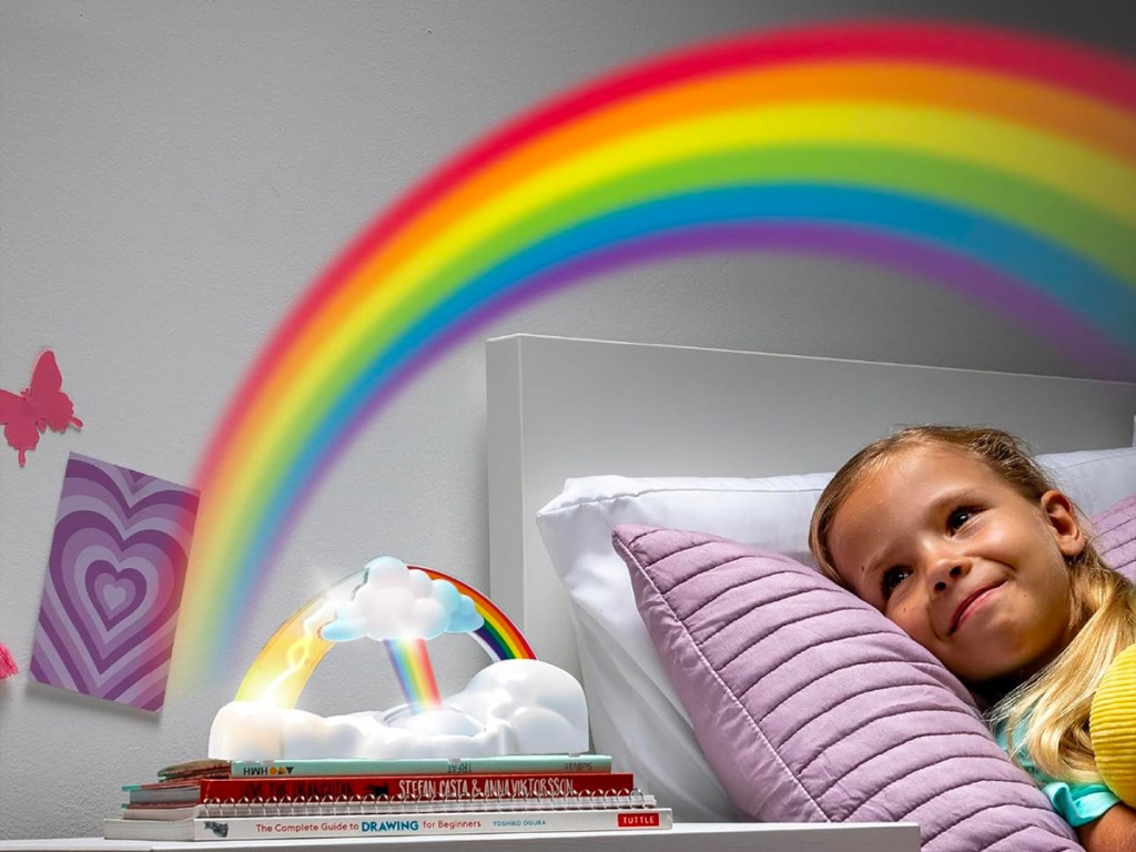 girl looking at rainbow light lit up in room