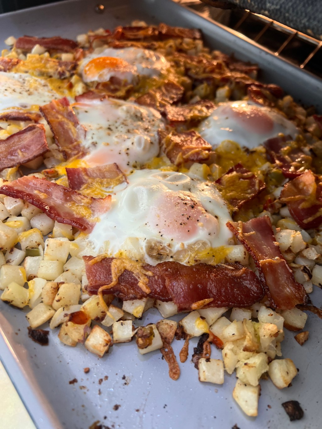 sheet pan eggs and bacon in the oven after baking