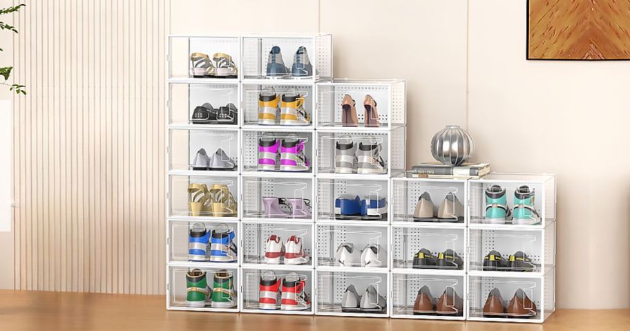 12 Pack of white Large Shoe Organizer Storage Boxes being used against a wall with shoes inside 