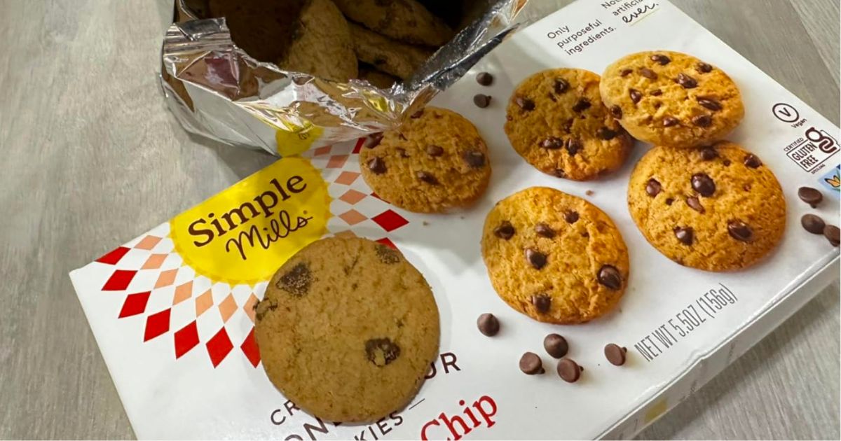 simple mills choc chip cookie box with open bag and one cookie displayed on a kitchne counter