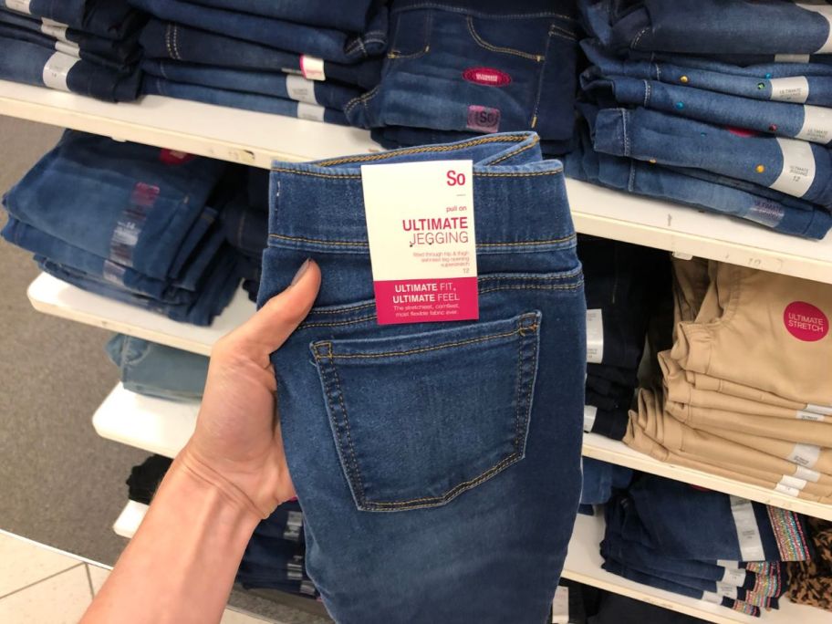 hand holding so jeans in store