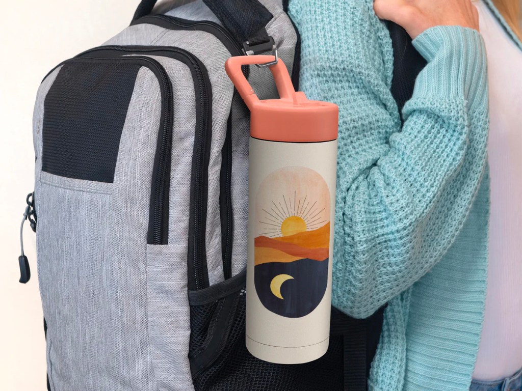 water bottle with sunset on it hooked onto backpack
