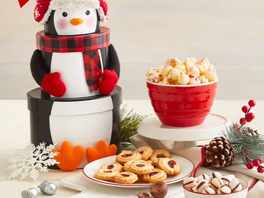 penguin tower with bowl of popcorn and plates with cookies