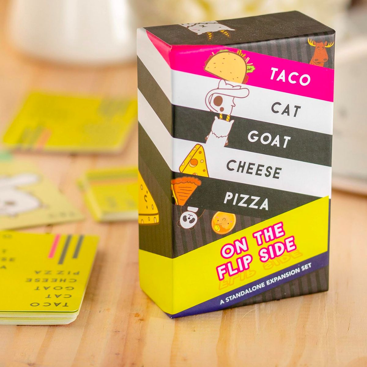 taco cat goat cheese pizza on the flip side card box and cards on a table
