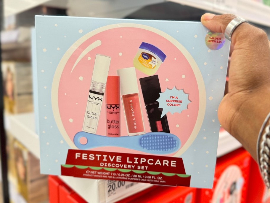 hand holding a box with a Festive Lipcare Lip Discovery gift set