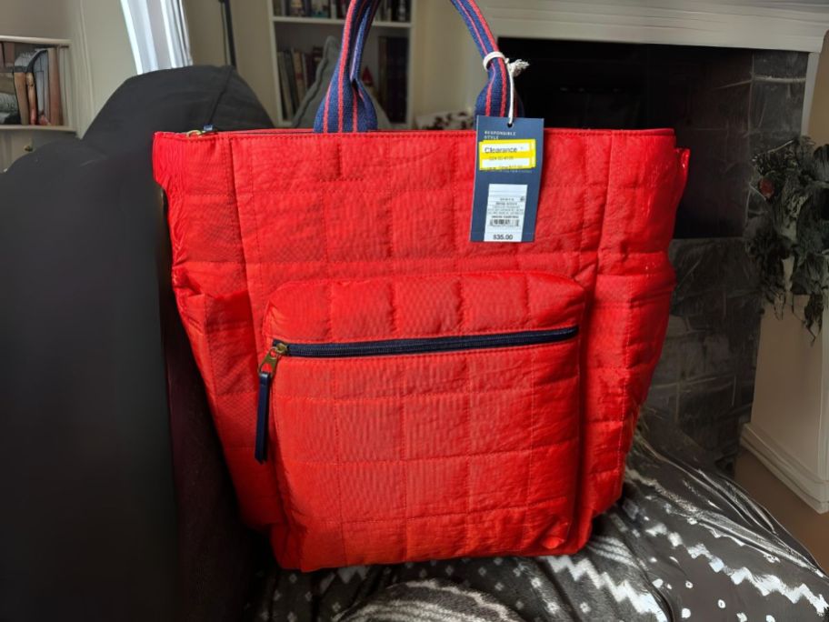 red quilted style handbag with handles and backpack straps
