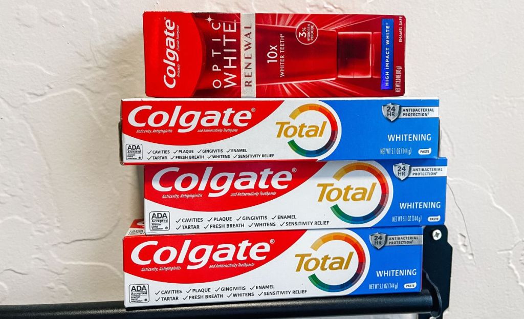 4 boxes of colgate toothpaste stacked on top of each other