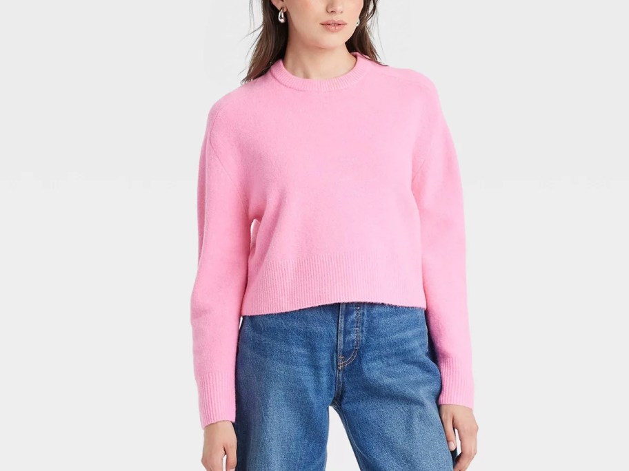 woman wearing pink sweater and blue jeans