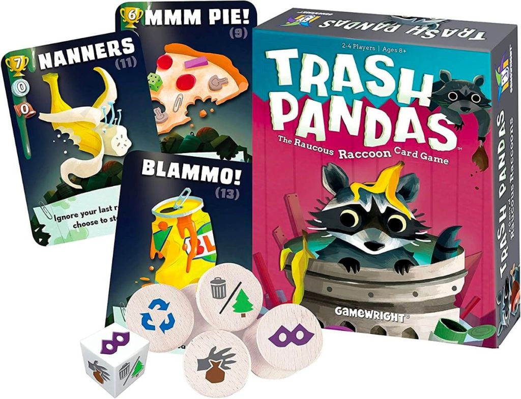 trash pandas card game spread out on a table next to a stuffed panda (not a raccooon)