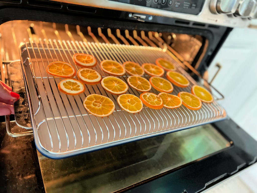 tray with dried orange slices in the oven drying 