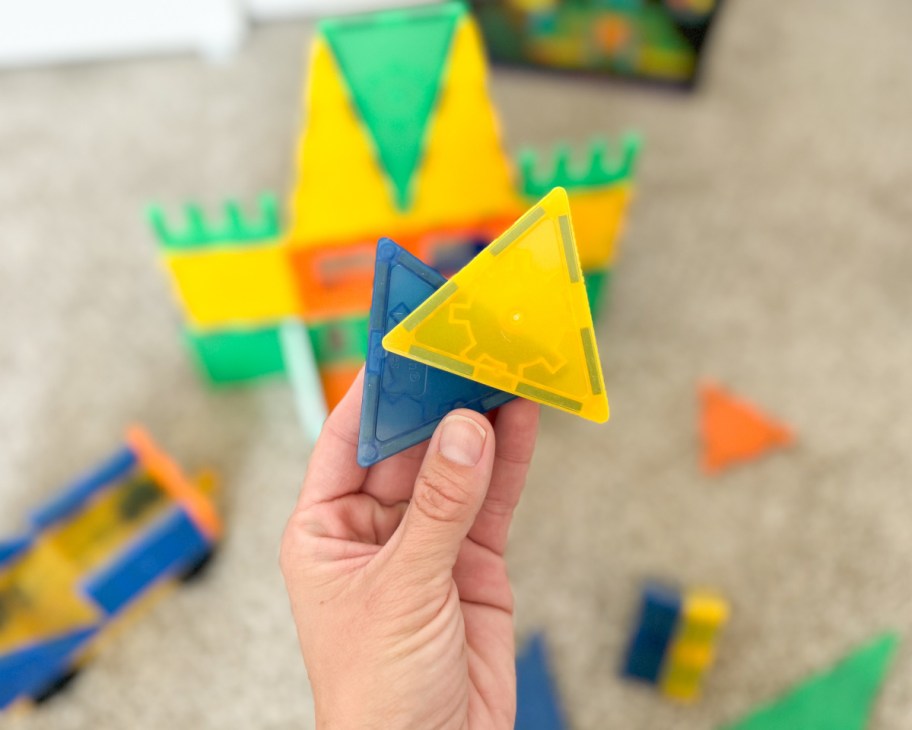 hand holding magnetic tiles