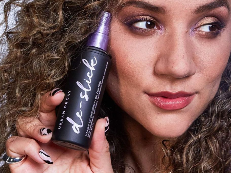 person holding Urban Decay De-Slick Mattifying Makeup Setting Spray