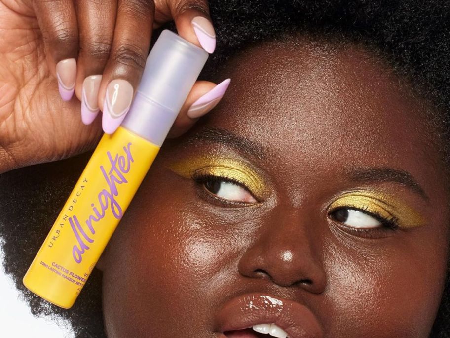 girl holding Urban Decay All-Nighter Vitamin C Hydrating Makeup Setting Spray