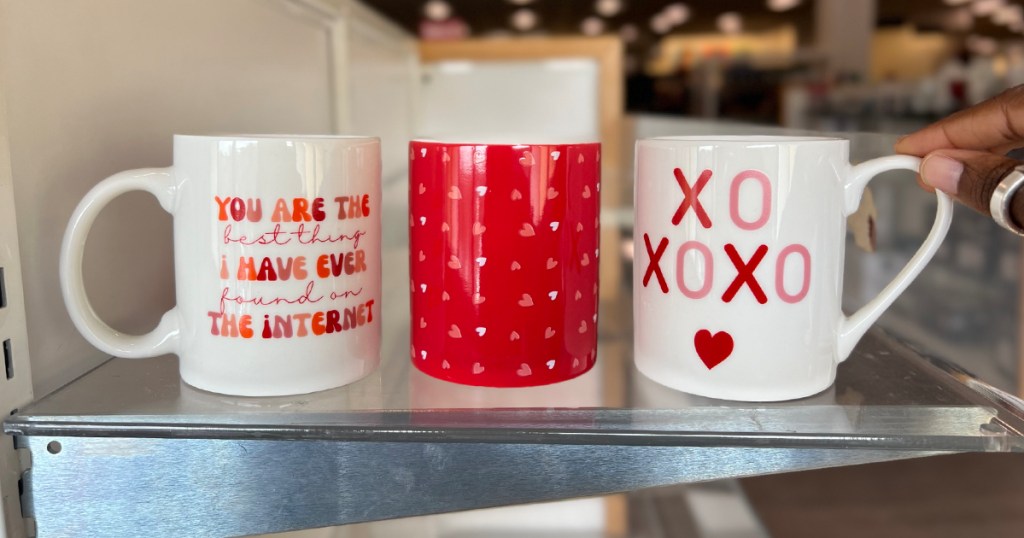 valentines day mugs on glass store shelf