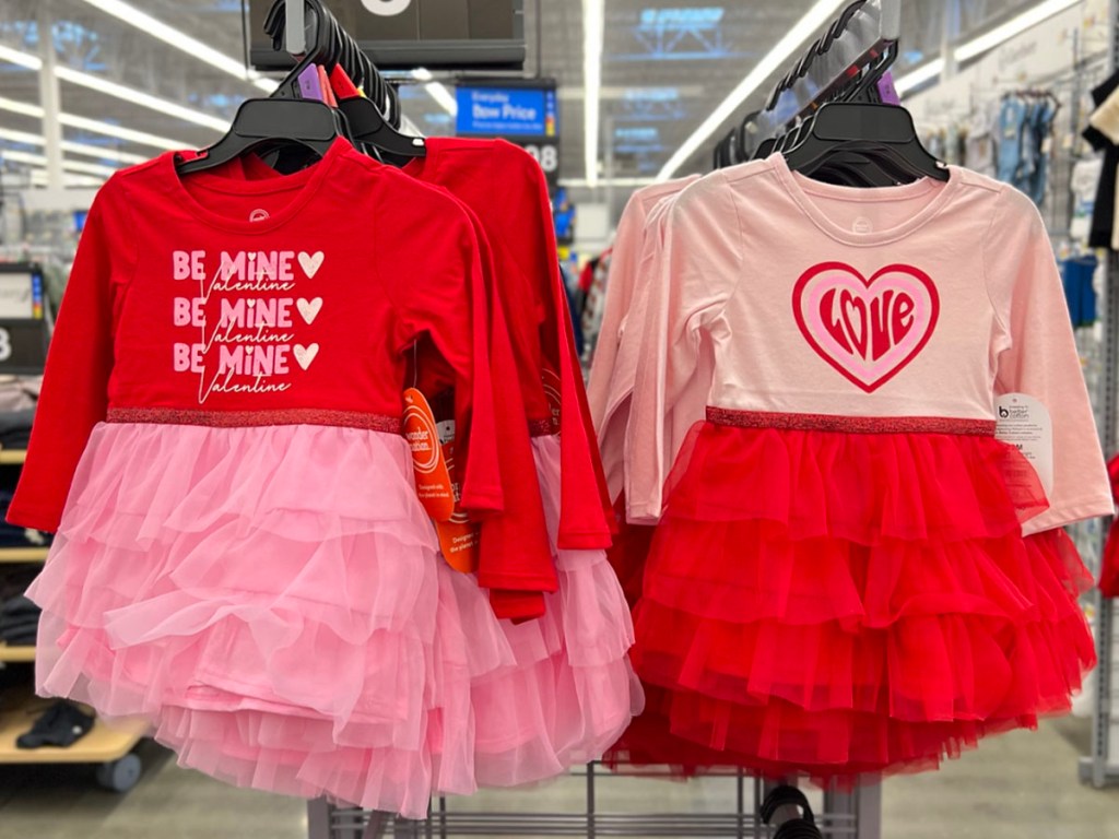 pink and red toddler valentines dresses hanging in walmart