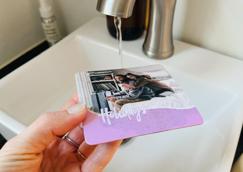 holding photo coaster under faucet